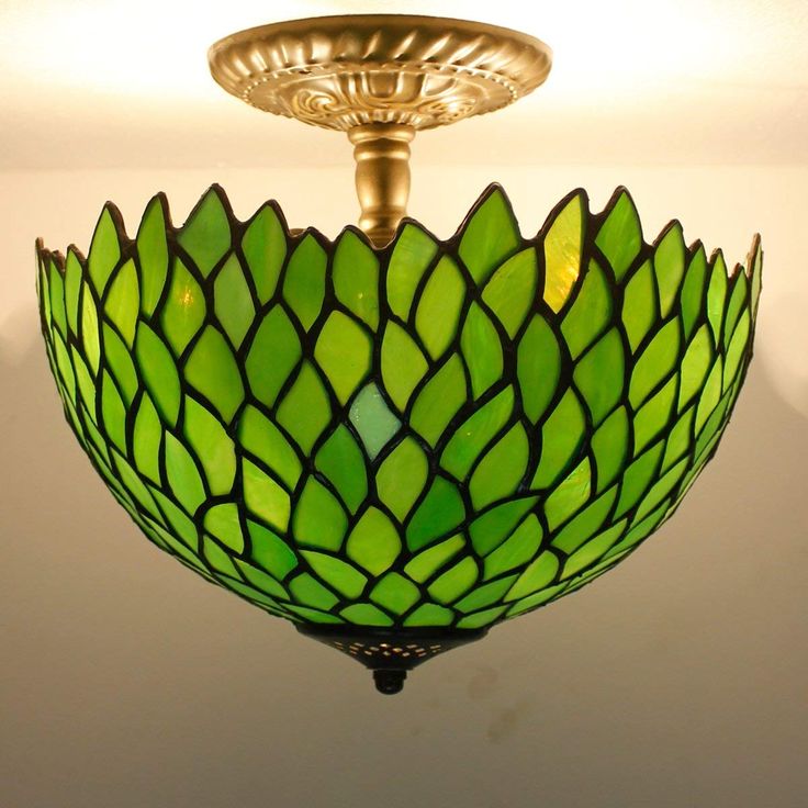 a green light fixture hanging from the ceiling