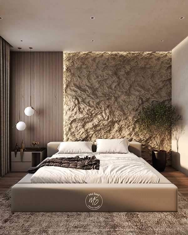 a large bed sitting in the middle of a bedroom next to a wall mounted plant