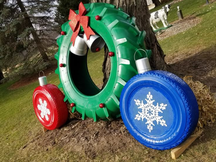 two frisbees and a snowflake on the ground in front of a tree