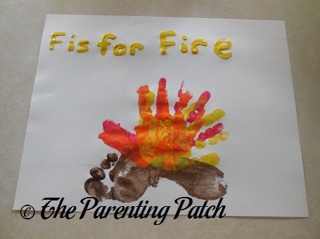 a paper sign that says, fist for fire the parent's hand is painted