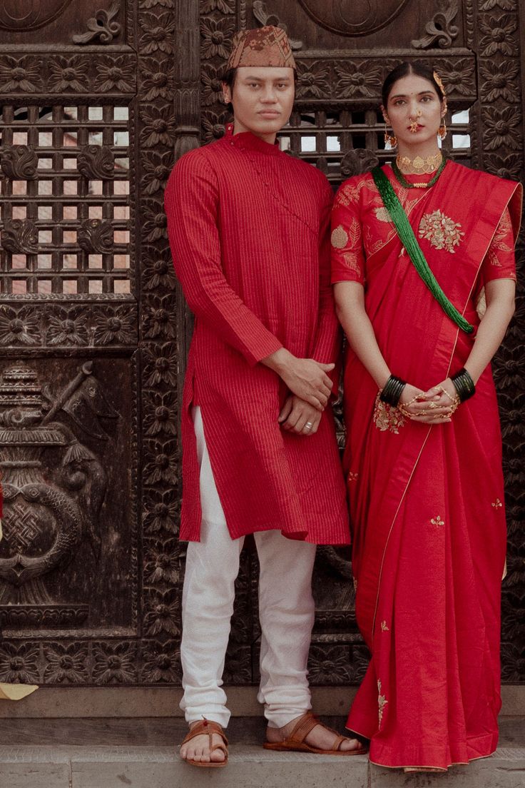 Maroon chanderi kurta with zari lines, high neck collar and asymmetric button placket. Paired with cotton nizam border fabric churidar.
Component: 2
Pattern: Woven
Type Of Work: Stripes
Neckline: High Neck Collar
Sleeve Type: Full Sleeves
Fabric: Kurta: Chanderi, Churidar: Cotton Nizam Border Fabric
Color: Maroon
Other Details: 
Note: The saree worn by  the female model is not for sale
Occasion: Sangeet,Mehendi and Puja - Aza Fashions Fitted Handloom Kurta For Traditional Ceremonies, Designer Slub Silk Sherwani With Traditional Drape, Cotton Silk Kurta With Dupatta For Traditional Ceremonies, Chanderi Sherwani For Traditional Ceremonies, Navratri Kurta With Traditional Patterns And Drape, Festive Cotton Silk Bandhgala With Traditional Drape, Festival Cotton Silk Bandhgala With Dupatta, Straight Kurta For Navratri Traditional Ceremonies, Transitional Kurta With Traditional Patterns And Drape