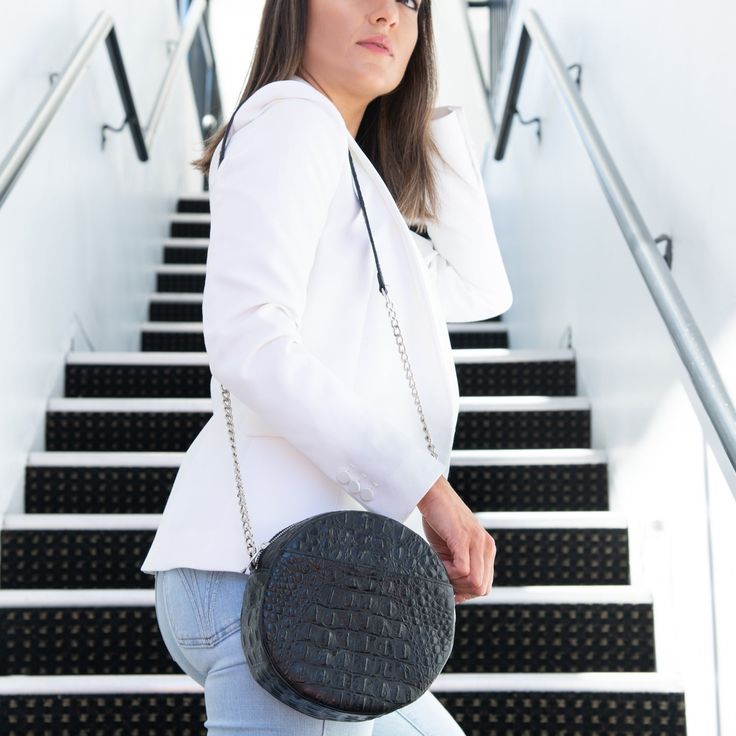 The always on-point classic black purse keeps you moving from work to play. The Classic Black Circle Purse’s updated design is a perfect blend of fashion and function with a front pocket for your cell phone and the addition of UCAN Luxury Zippers. Circle Cross-body purse Top Zipper - USA Front Cell Phone Pocket Inner Pouch Pocket Chain and Leather Strap Blue Berry Lining Black Leather - USA Approx: L 8” X H 8" X W 3" Strap: 48” Manufactured in Los Angeles, CA Modern Shoulder Bag With Hidden Phone Sleeve, Versatile Formal Bags With Cell Phone Pocket, Versatile Formal Bag With Cell Phone Pocket, Modern Black Bag With Hidden Phone Sleeve, Black Crossbody Bag With Hidden Phone Sleeve, Formal Black Shoulder Bag With Cell Phone Pocket, Formal Black Bag With Cell Phone Pocket, Pocket Chain, Circle Purse