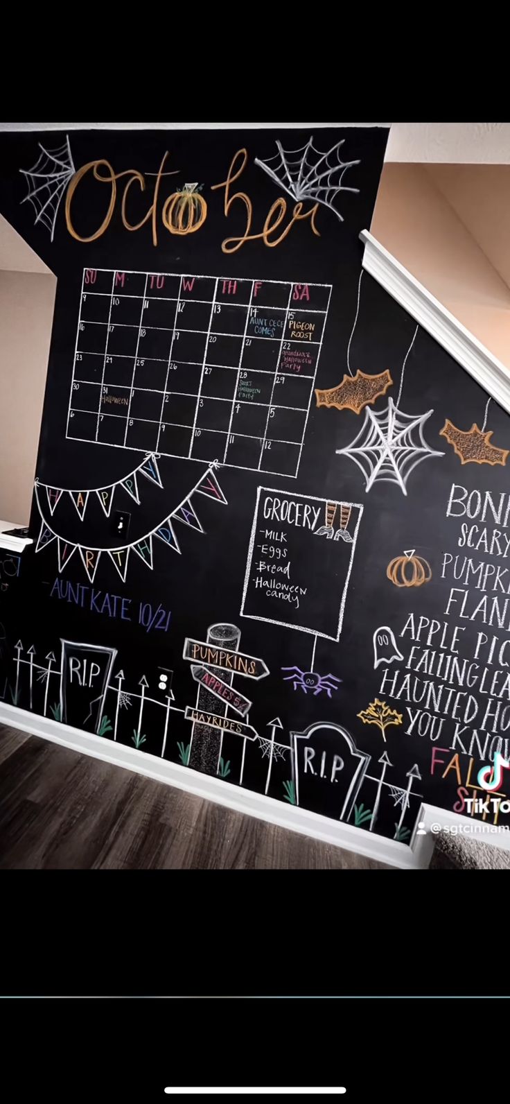 a blackboard with chalk writing on it that says october and is decorated with halloween decorations