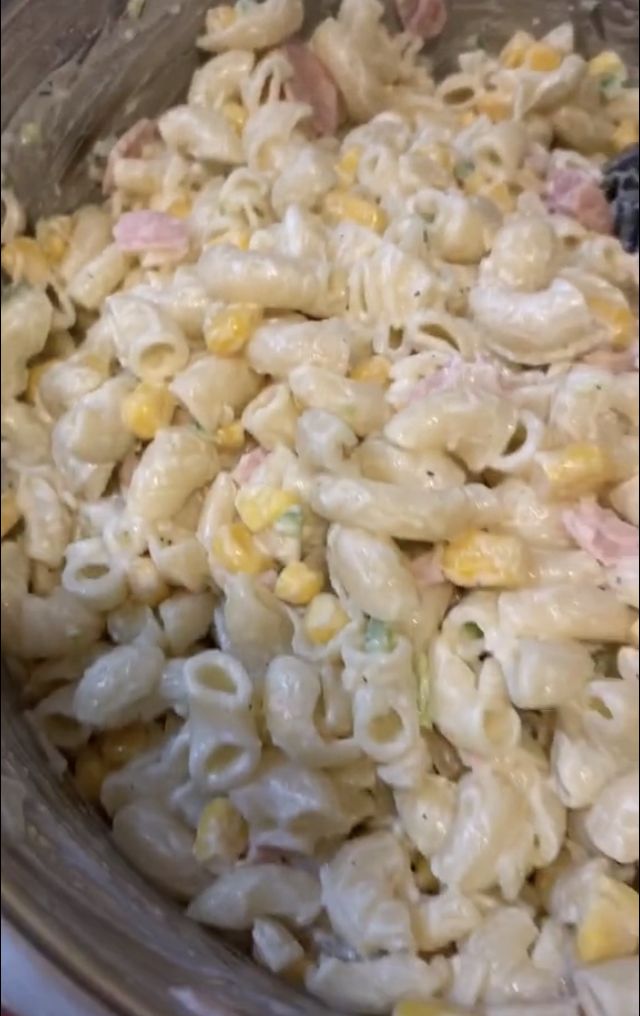 macaroni and cheese is mixed together in a crock pot with some other ingredients