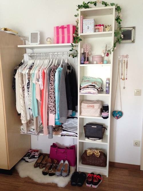 an organized closet with shoes, handbags and purses on the floor in front of it