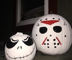 two halloween pumpkins with faces painted on them