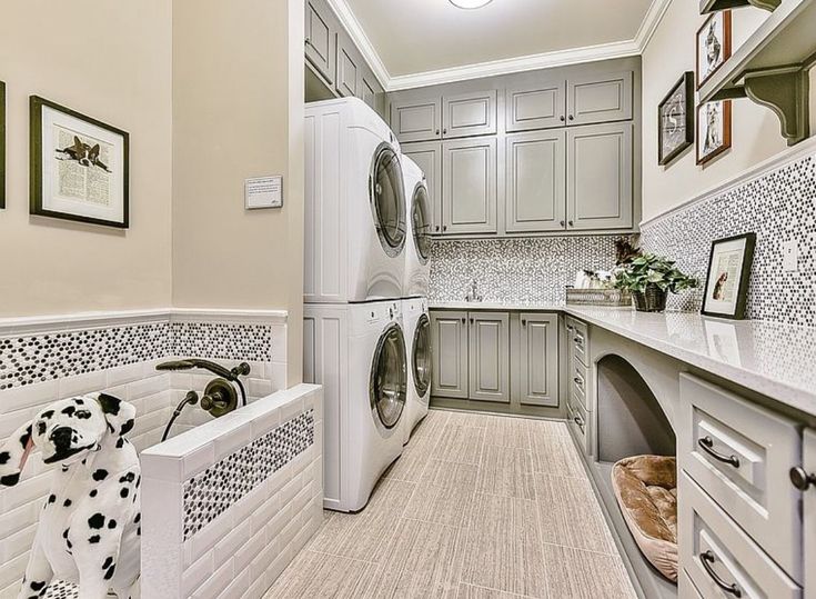 a washer and dryer are in the middle of a long narrow laundry room