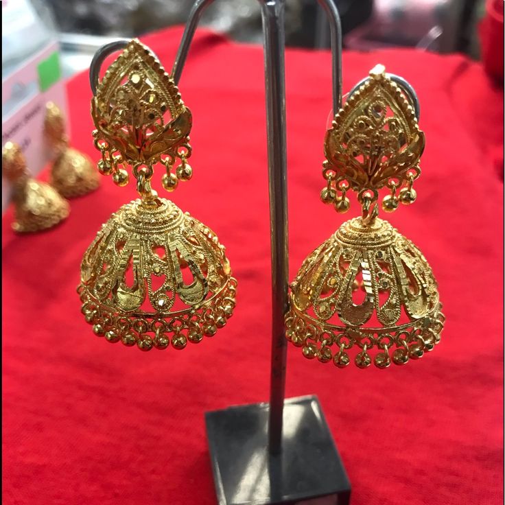 Gold Plated Jhumka Gold Chandbalis With Cutdana Detail, Navratri Gold Danglers With Zari Work, Gold Cutdana Jhumkas For Eid, Chandbali Jhumkas For Eid, Gold Bollywood Style Jhumkas, Bollywood Style Jhumkas With Intricate Design For Eid, Eid Festival Chandbali Jhumkas, Bollywood Style Intricate Jhumkas For Eid, Bollywood Style Intricate Design Jhumkas