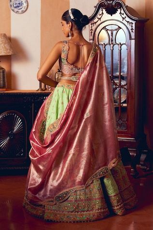 Light green jacquard silk banarasi lehenga with floral, gota, zari and zardosi embroidery. Paired with coordinating paisley motif pearls and dabka embroidered cutwork lace blouse, belt and dupatta. - Aza Fashions Art Silk Dupatta With Tilla For Reception, Reception Art Silk Dupatta With Tilla Detail, Reception Raw Silk Dupatta With Tilla Detail, Raw Silk Tilla Dupatta For Reception, Silk Meenakari Choli For Reception, Wedding Choli With Tilla Detail In Brocade, Wedding Choli With Tilla In Brocade, Silk Choli With Tilla For Wedding, Wedding Dupatta In Brocade With Tilla Detail