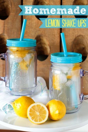 two mason jars filled with lemons sitting on top of a white plate next to each other