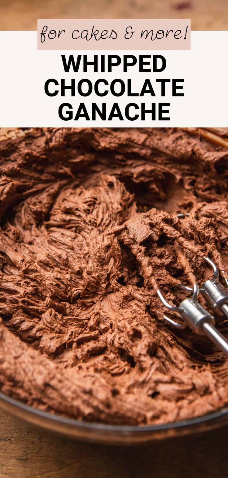 a bowl filled with whipped chocolate ganache and two metal utensils in it