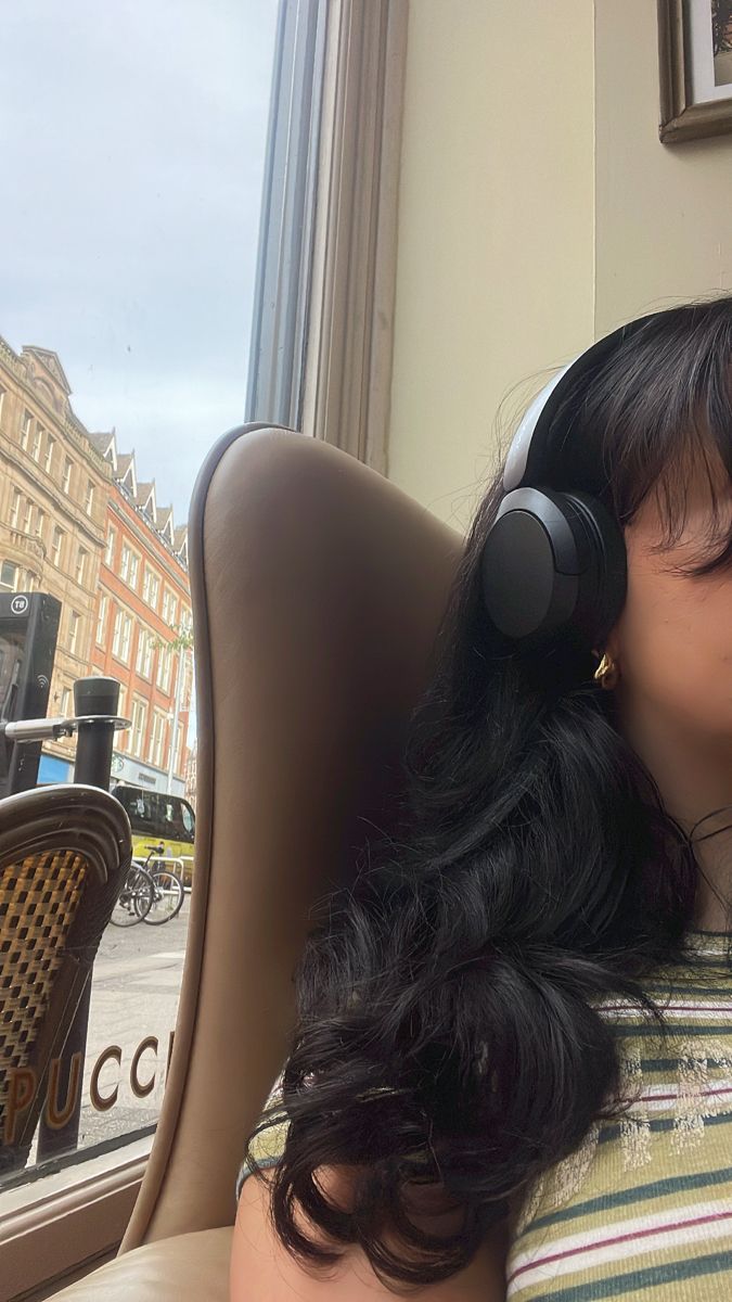 a woman wearing headphones sitting in a chair