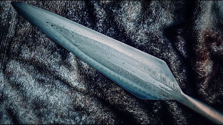 a large metal object laying on top of a black blanket covered in fur and fabric