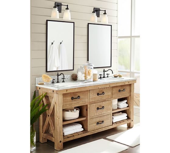 a bathroom with two sinks, mirrors and towels on the counter top in front of it