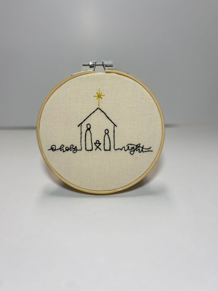 a small embroidered hoop with the words, jesus is coming up from his house and there is a star above it