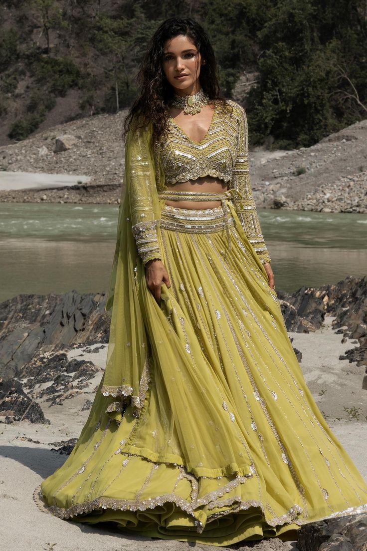 Citrus lehenga with mirror, sequin and pearl embroidery. Paired with embroidered blouse and embroidered dupatta.
Component: 3
Pattern: Embroidered
Type Of Work: Mirror, Sequins and Pearls
Neckline: V Neck
Sleeve Type: Full Sleeves
Fabric: Georgette
Color: Green
Other Details: 
Mirror and sequin work
Note: Belt worn by the model is not for sale
Occasion: Wedding,Bride - Aza Fashions Kundan Sets With Sequins For Reception, Party Wear Kundan Lehenga With Mirror Work, Eid Embellished Pista Green Lehenga, Navratri Sequin Lehenga In Chinon, Dola Silk Lehenga With Sequins For Navratri, Navratri Dola Silk Lehenga With Sequins, Party Wear Lehenga With Cutdana Detail, Party Wear Lehenga With Cutdana On Chinon, Sequin Chinon Lehenga For Navratri