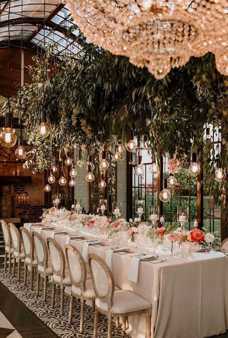 an elegant dining room with chandeliers and tables set for a formal dinner party