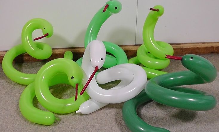 some green and white balloons are laying on the floor