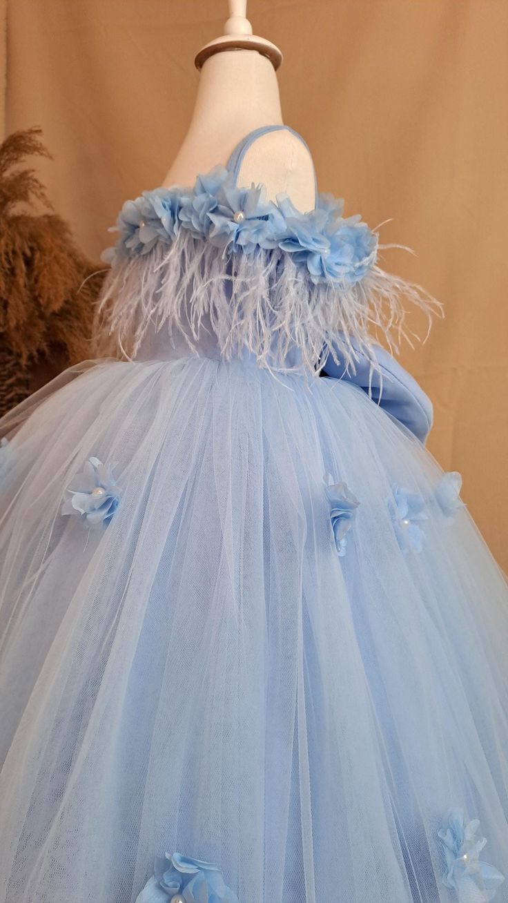 A blue flower girl dress is a charming and elegant garment designed for girls to wear as part of a party.  ⭐️⭐️⭐️⭐️⭐️ Typically crafted from soft fabrics like crepe, tulle, this dress features a beautiful blue color that adds a touch of sophistication to the occasion ⭐️⭐️⭐️⭐️⭐️  The design often includes delicate floral accents, such as embroidered flowers or appliqués, which enhance its visual appeal. ⭐️⭐️⭐️⭐️⭐️ item details * One dress, hair accessory * Material: crepe, tulle  * Sizes of flowers: 5 cm ✈️ Shipment and delivery ⭐️⭐️⭐️⭐️⭐️ Best customer service on Etsy 🚀🚀 Shipment in 10-15 workdays after payment. 🚀🚀 Worldwide express shipping ( Fedex Shipping ) 1-5 workdays. EVERYTHING IS FOR  Please visit my store for my other models. https://www.etsy.com/shop/SevgiDesigner HOW TO ORDE Elegant Blue Princess Dress For Baptism, Blue Princess Dress With Tulle Skirt For Wedding, Blue Tulle Dress For Dress-up, Blue Tulle Dress For Dress-up Occasions, Blue Tulle Skirt Dress For Dress-up, Blue Dress With Tulle Skirt For Dress-up, Elegant Blue Tutu Dress For Baptism, Elegant Blue Tutu Dress For Wedding, Elegant Blue First Communion Dress