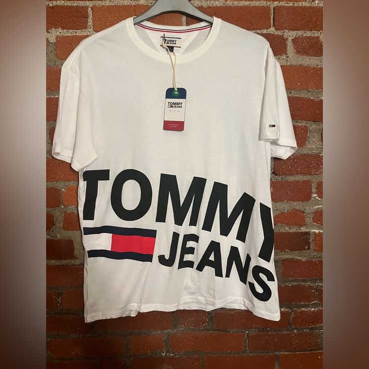 When You Bundle 3+ Items You Receive Discounts And Only Will Pay One Shipping Fee! Most Items Ship Next Day Except Friday-Saturday And Holidays! Please Note Items May Come From Pet Households, All Items Are Clean And Washed But There Still May Be Some Pet Hair Caught In The Fabric! Trendy Tommy Hilfiger Cotton T-shirt, White Cotton Tommy Hilfiger T-shirt, Tommy Hilfiger Graphic Tee With Letter Print, Tommy Hilfiger White Crew Neck Top, Trendy Tommy Hilfiger Cotton Tops, Tommy Hilfiger Cotton T-shirt With Letter Print, Tommy Hilfiger Relaxed Fit Tops With Logo Print, Tommy Hilfiger Relaxed Fit Logo Print Tops, Trendy Tommy Hilfiger Tops With Graphic Print