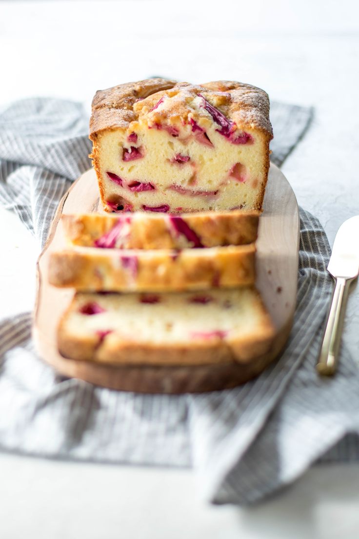 a loaf of raspberry bread sitting on top of a cutting board