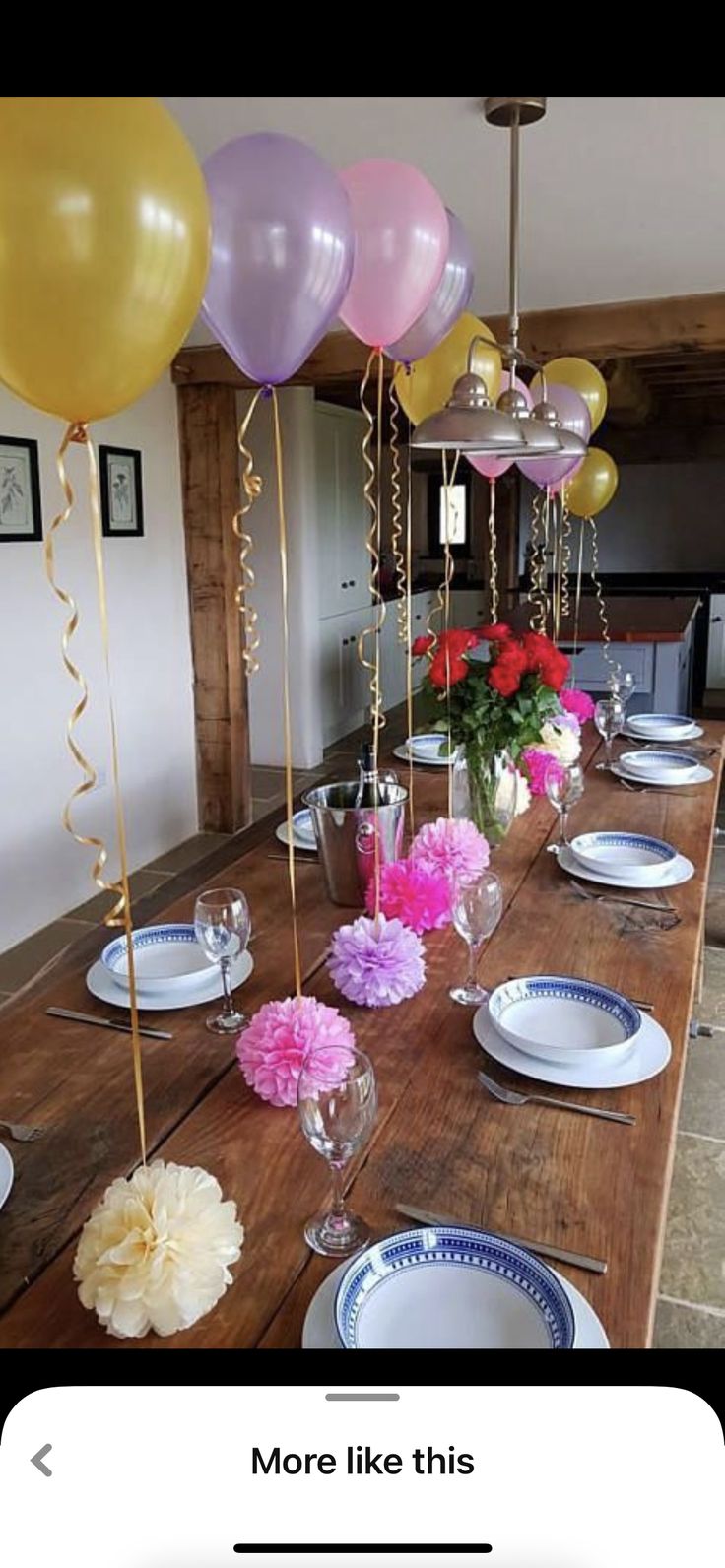 the table is set with balloons and plates