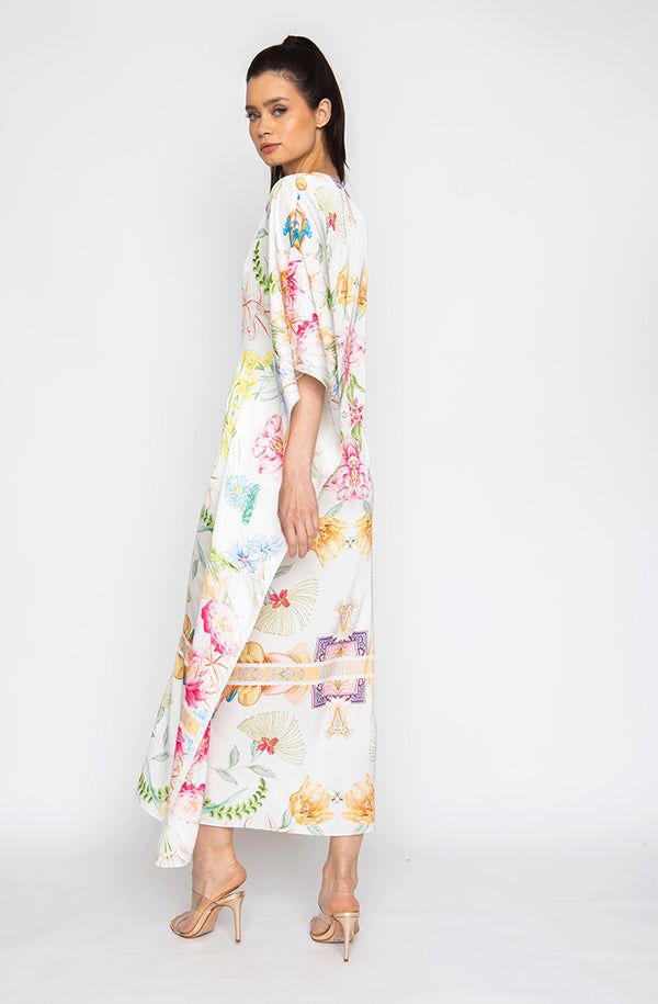 Bring out your inner flower in the Botanica Long Caftan. This gorgeous piece of apparel features delicate flowering patterns, giving you the freedom to show off your unique style. And the airy fabric won’t weigh you down, meaning you can wear your beauty around the clock! Bloom into something special with the Botanica Long Caftan. Printed short caftan Can be worn loose or cinched at the waist Comes with a matching belt as an option for styling Lusciously soft poly-silk blend for ease of care Mac Summer Floral Print Maxi Kimono, Floral Print Maxi Kimono For Summer, Spring Beach Cover-up Maxi Dress With Kimono Sleeves, Spring Vacation Maxi Dress With Kimono Sleeves, White Bohemian Maxi Kimono, White Bohemian Maxi Length Kimono, Spring Maxi Dress With Kimono Sleeves For Beach Cover-up, Spring Kaftan With Kimono Sleeves For Daywear, Spring Summer Daywear Kaftan