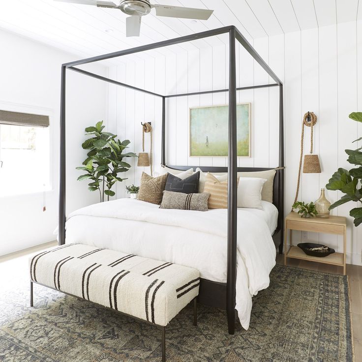 a bedroom with a canopy bed and white walls