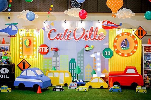 a display with cars, stop signs and balloons