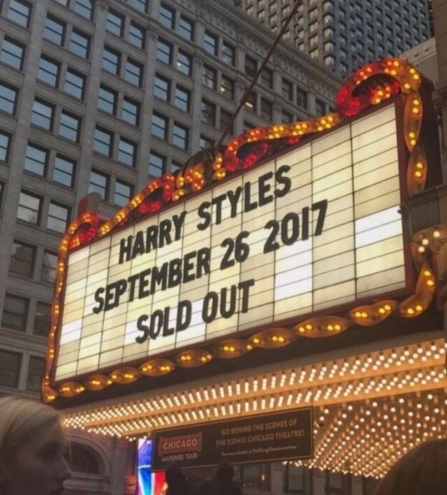 the marquee for harry styles is lit up in front of a large building