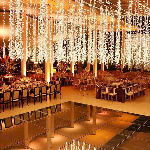 an indoor wedding venue with chandeliers and tables set up for a formal function