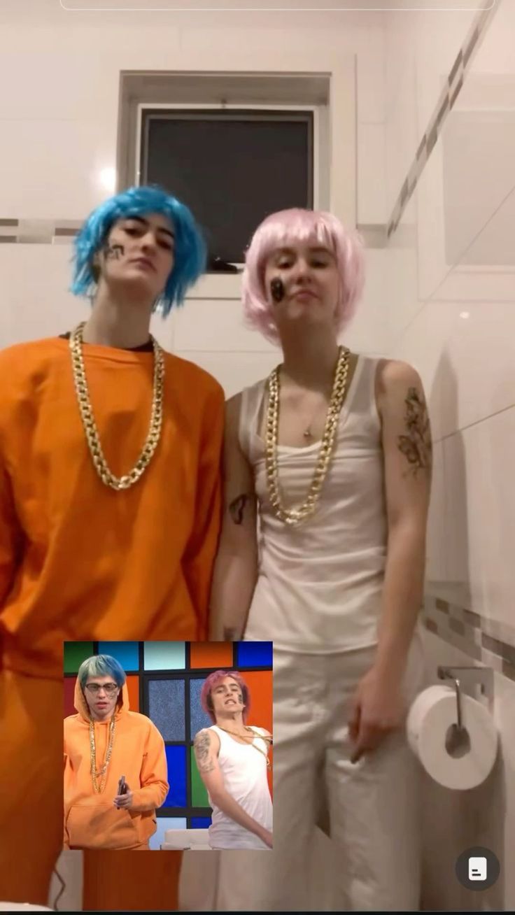 two people standing next to each other in a bathroom with blue hair and piercings