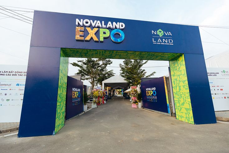 the entrance to an expo is decorated in bright colors and stands tall with trees on either side