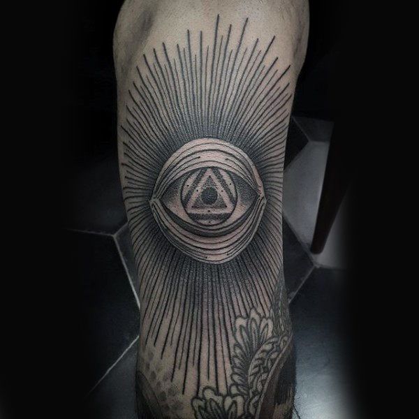 a man's leg with an all seeing eye tattoo on it