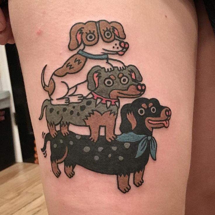 a woman's thigh with an image of two dogs on top of each other