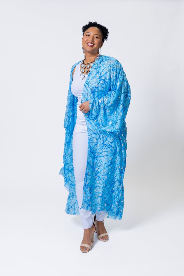 Elevate your summer style with the elegant touch of silver featured in this lightweight kimono. Its versatility makes it ideal for beach days, lunches, or date nights, ensuring you'll make a statement wherever you go this season. Elegant Blue Kimono For Summer, Elegant Spring Beach Kaftan, Light Blue Summer Kaftan, Wrap Kaftan For Beach Cover-up In Spring, Elegant Summer Kimono With Open Front, Blue Wrap Kimono For Beachwear, Summer Light Blue Kaftan, Elegant Summer Vacation Kimono, Spring One Size Long Kaftan