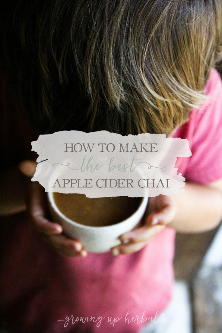 a person holding a cup with the words how to make the best apple cider chai