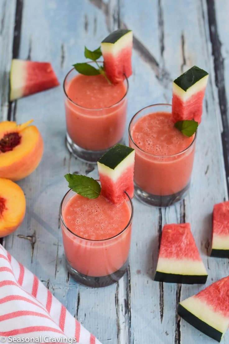 watermelon, peach and mint smoothie recipe on a blue wooden table with slices of fruit