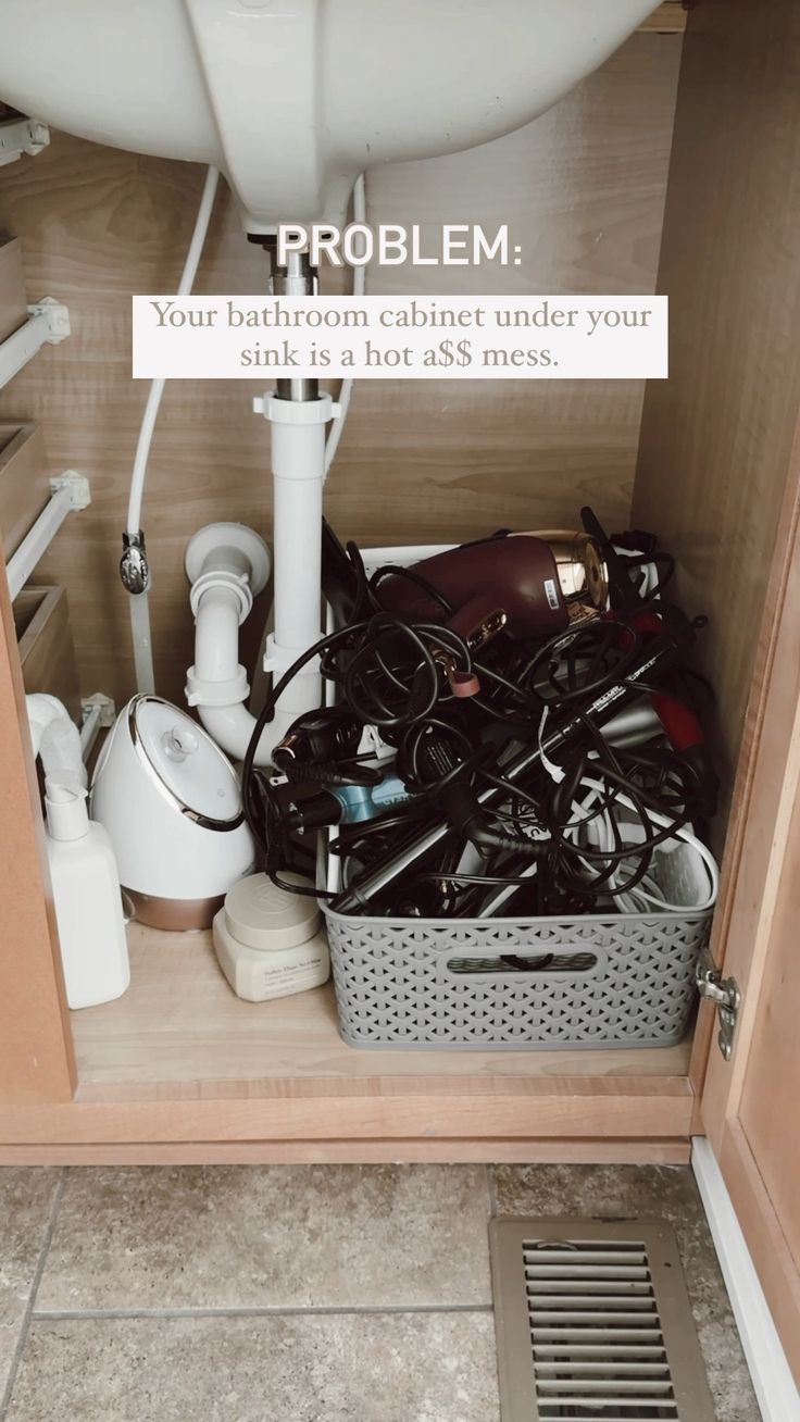 the bathroom cabinet is filled with toiletries and other household care items that are under the sink