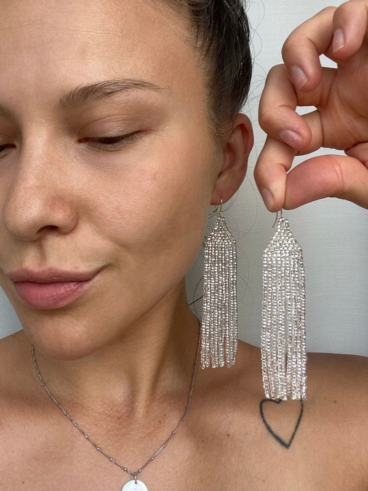 Shiny silver seed bead earrings are made from selected Czech beads. It can be an excellent personalized gift for bridesmaids, Mothers Day, birthdays, Valentine's Day, Wedding day, Christmas, New Year, and for your loved ones. ♡ Beveled earrings: Length - 4.3'' (11 Centimeters) ♡ Width - 1,2'' (3 Centimeters) ♡ Streight earrings: Length - 3.7'' (9,5 Centimeters) ♡ Width - 1'' (2,5 Centimeters) ♡ Quality Czech beads ♡ Stainless steel hooks If you like these bright glossy beaded earrings but would Czech Beads Jewelry, Beaded Jewelry Earrings, Evening Earrings, Pastel Earrings, Bridal Earrings Chandelier, Loom Jewelry, Earrings Chandelier, Native American Beaded Earrings, Handmade Earrings Beaded