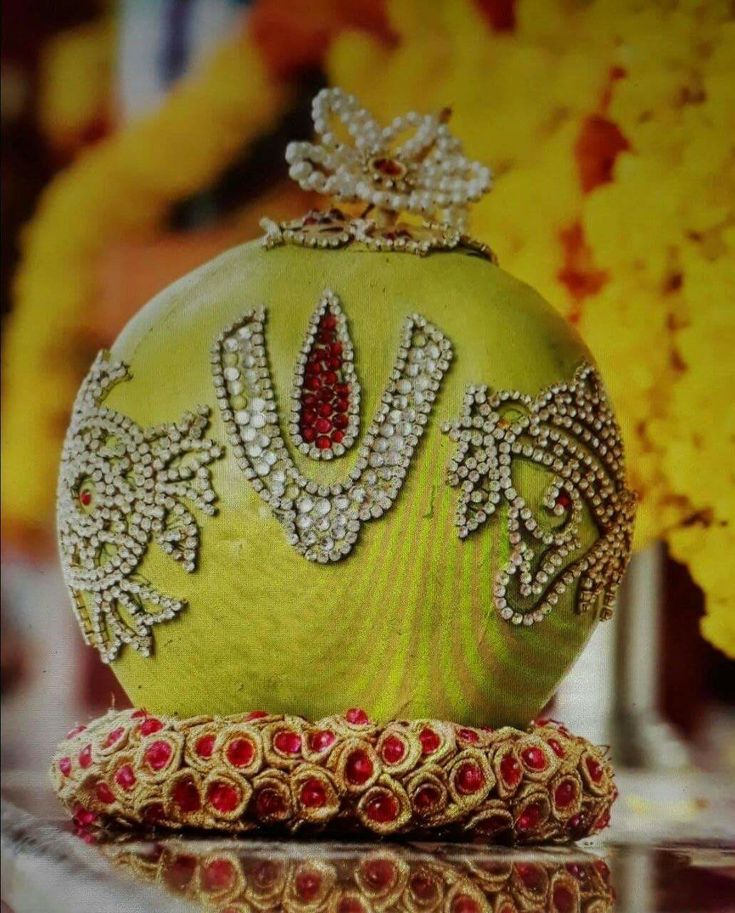 a green purse sitting on top of a table next to some yellow and red flowers