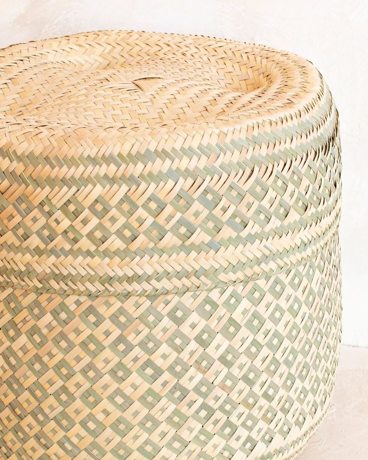 a large woven basket sitting on top of a white floor