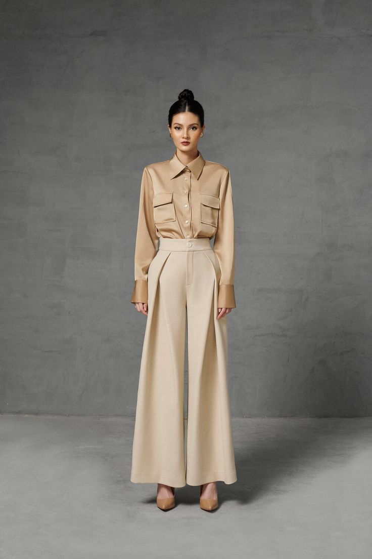 Designed with draped wide legs on a gentle beige tone which is very flattering to the wearer's skin the pants bring both youthfulness and elegance to the wearer. A unique design that created an eye-catching effect that easily capture all eyes. Note:*Processing time takes 7-10 working days (including 3-5 working days for manufacturing and NOT including shipping time)**Backorder Definition- The product is low in stock and in case the customer purchased successfully after out stock, the order will Chic Beige Wide-leg Culottes, Elegant Beige Pants, Elegant Beige Wide Leg Culottes, Beige Wide Leg Culottes For Workwear, Elegant Beige Bottoms, Elegant Cream Wide Leg Pants, Elegant Beige High-waisted Culottes, Chic Beige Wide Leg Pants For Formal Occasions, Beige Pants For Spring Evening