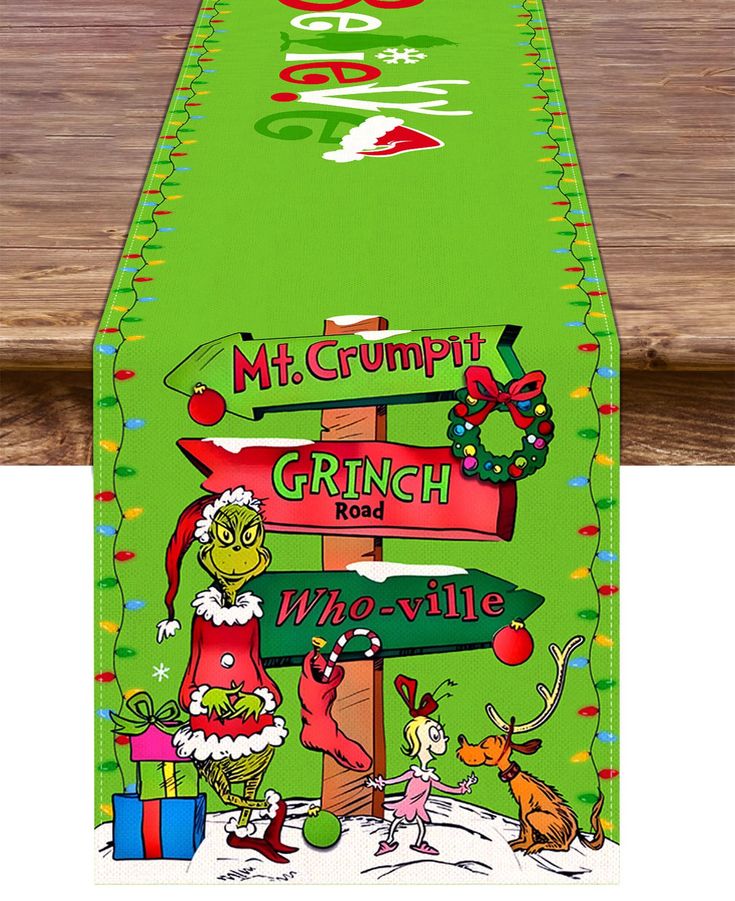 a green table runner with christmas signs on it