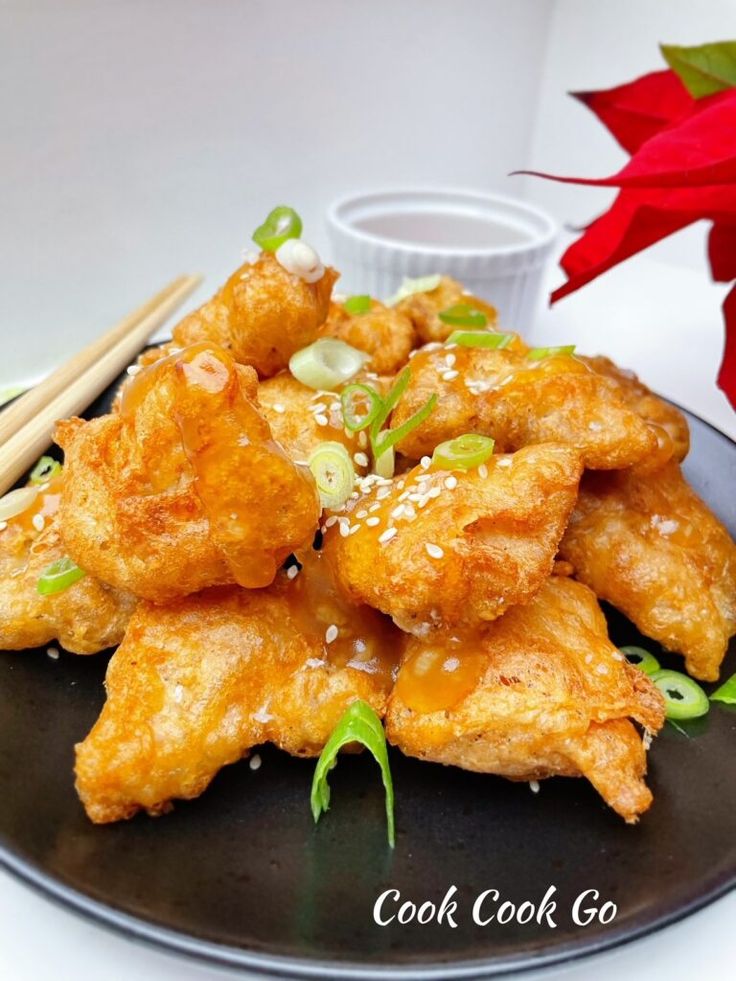 a plate with some fried food and chopsticks on it