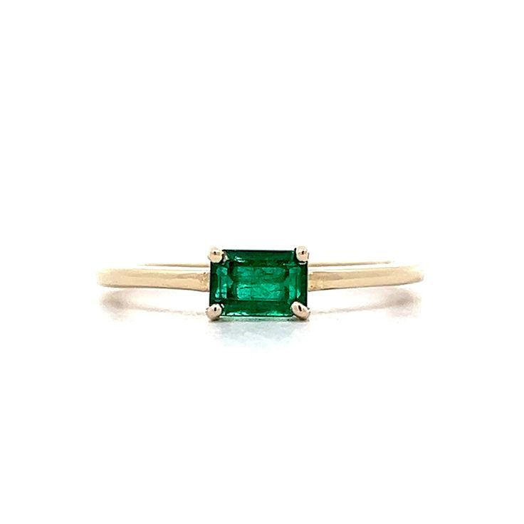 Emerald Stacking Ring in 14k Yellow Gold This modern solitaire and stacking ring features an eye-catching .56 carat emerald cut emerald set in 14 karat yellow gold. The emerald cut emerald reflects a dazzling green hue. This solitaire design has the stone set east/west, allowing the ring to be stacked with others. PRIMARY STONE Stone: Emerald Shape: Emerald Weight: .56 ct Measurements: 5.52 mm x 3.72 mm x 3.22 mm CHARACTERISTICS Ring Size: 7.0 Resizable: Yes Height Above Finger: 4.90 mm Measurem Modern Emerald-cut Green Diamond Ring, Emerald Ring With Single Diamond For Anniversary, Classic Green Stackable Rings With Prong Setting, Modern 14k Gold Emerald Cut Birthstone Ring, Modern Solitaire Emerald Cut Birthstone Ring, Classic Green Emerald Cut Stackable Rings, Modern Emerald Cut Solitaire Birthstone Ring, Classic Green Emerald-cut Stackable Rings, Green Ring With Single Diamond In Fine Jewelry Style