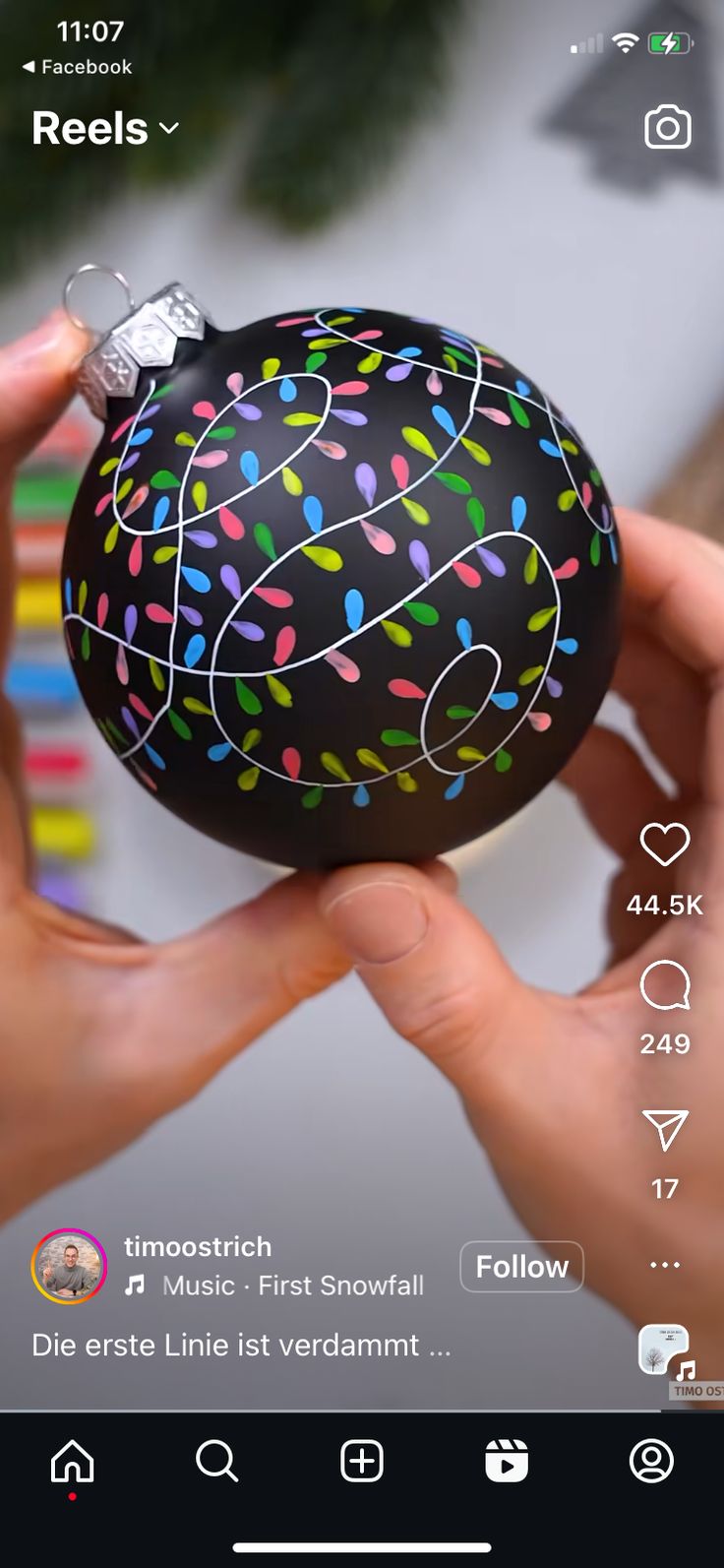 someone holding an easter egg decorated with sprinkles