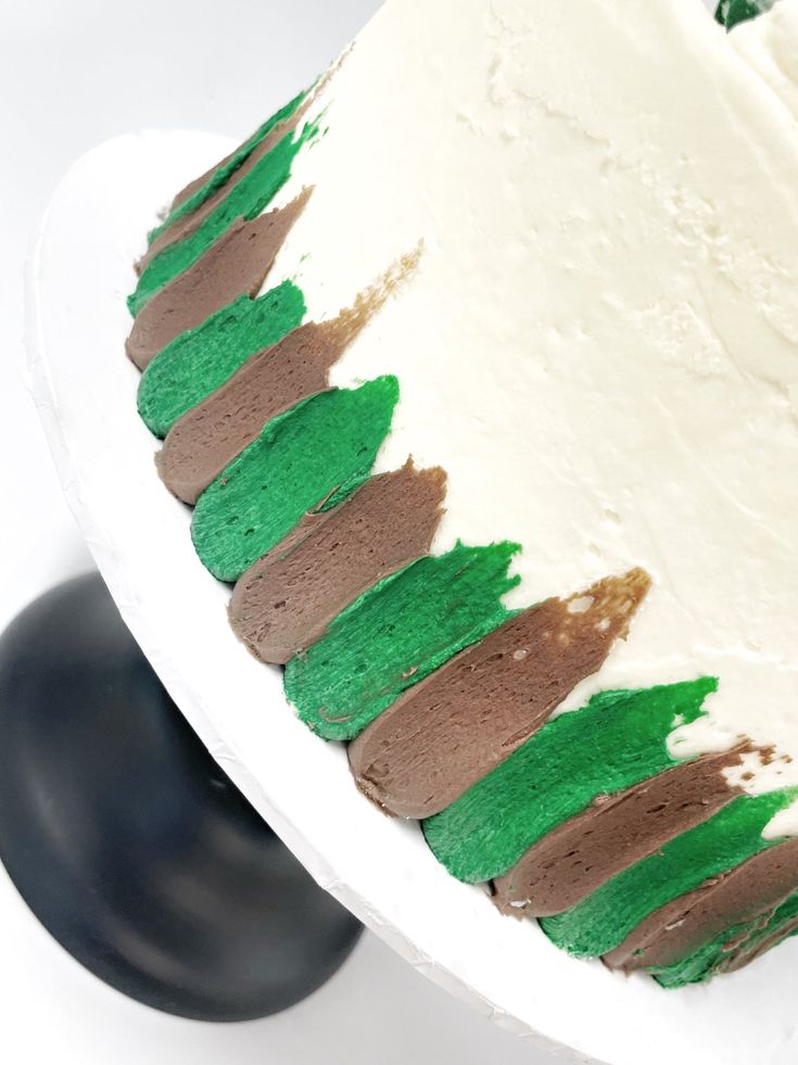 a cake with green and brown frosting on it