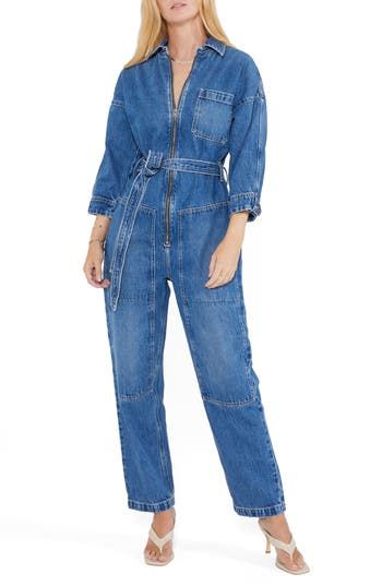 With a classic blue wash, this belted jumpsuit with a zip-front closure and plethora of pockets is a stylish way to make an all-denim statement. Point collar Three-quarter sleeves 77% cotton, 23% Tencel® Refibra™ lyocell Tencel Refibra lyocell is a sustainably produced fiber made from wood pulp and recycled cotton scraps using closed-loop processing Machine wash, line dry Imported Utility Style Belted Jumpsuit For Fall, Casual Denim Jumpsuit With Belt Loops For Work, Chic Denim Belted Jumpsuits And Rompers, Spring Utility Belted Jumpsuits And Rompers, Spring Denim Belted Jumpsuits And Rompers, Belted Utility Jumpsuits And Rompers For Spring, Belted Utility Jumpsuit For Spring, Casual Denim Belted Jumpsuits And Rompers, Fitted Utility Jumpsuits And Rompers With Belt