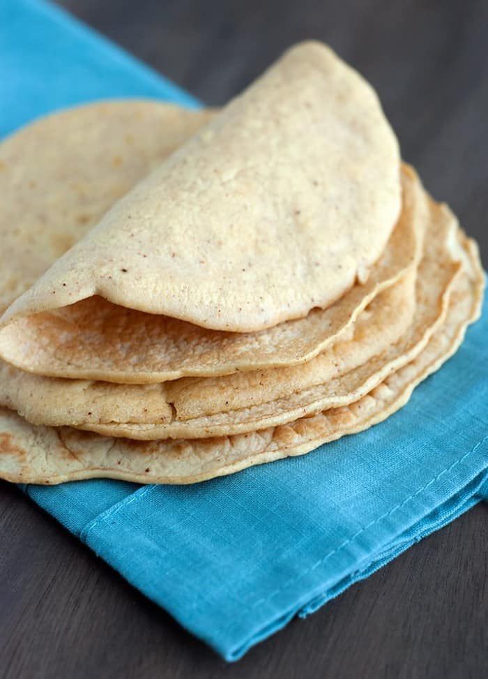 a stack of tortillas sitting on top of a blue napkin